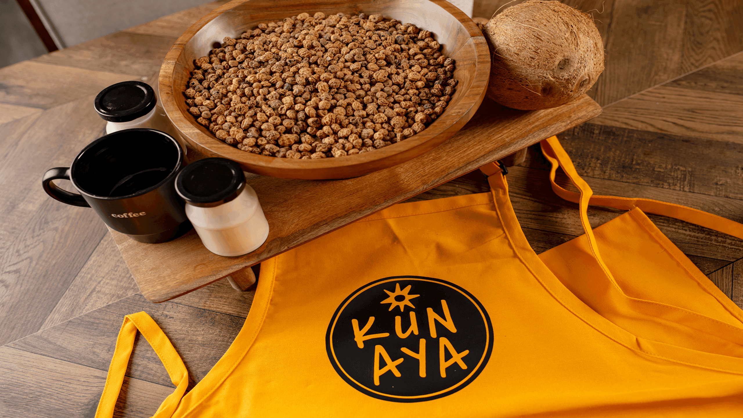 Kunaya ingredients with tiger nuts, coconut, and branded apron
